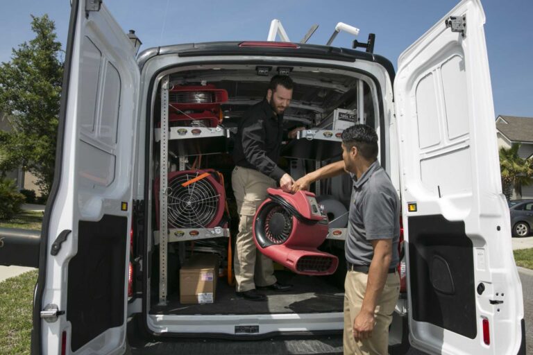 Commercial storm damage restoration crew in Livonia, MI unloading emergency drying and mitigation equipment for rapid storm damage recovery by Paul Davis Restoration of Livonia/Farmington MI